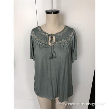 A short-sleeved blouse with tassel cut out